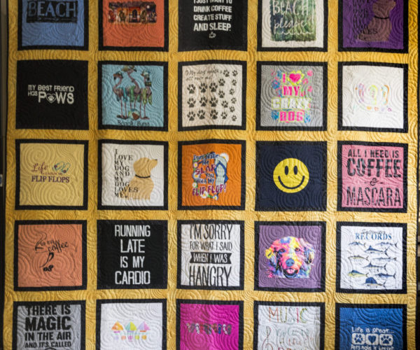 Our newest style is a framed block style.  With the blocks cut at just 12-1/2", this makes a great choice for collections of youth and smaller t-shirts.  With framing the block, the quilt reaches the same size as our traditional style.